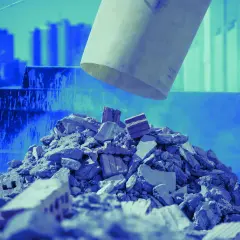 Cumulo di macerie e mattoni, residui di demolizione, con un tubo che scarica altro materiale.