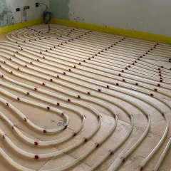 Installazione di tubi per riscaldamento a pavimento su pannelli isolanti. Un sistema efficiente per un comfort domestico.