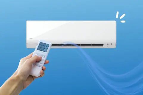 Un telecomando controlla un condizionatore per rinfrescare casa. L'aria fresca si diffonde creando un'atmosfera piacevole.