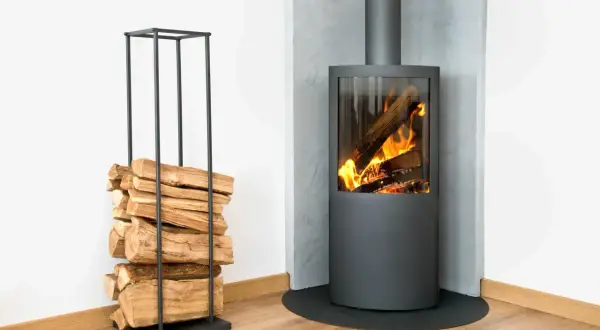 Stufa moderna con fiamme vive e legna accatastata in un elegante porta legna, per un accogliente riscaldamento a legna.