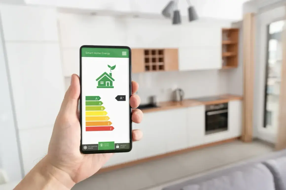 Smartphone mostra un'app per la gestione dell'energia domestica con un grafico della classe energetica.